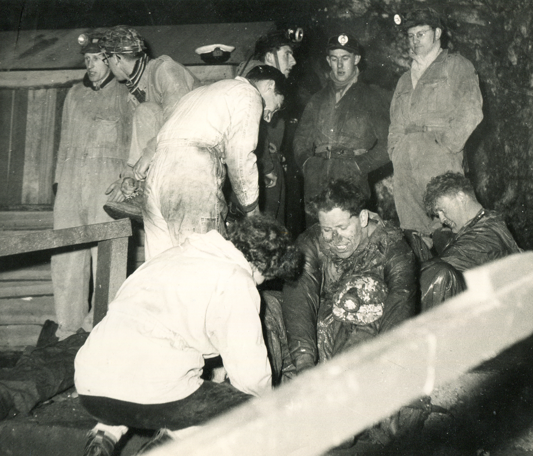 Muddy cavers in the vestibule